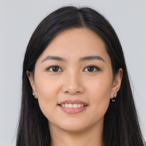 Joyful asian young-adult female with long  brown hair and brown eyes
