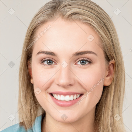 Joyful white young-adult female with long  brown hair and blue eyes