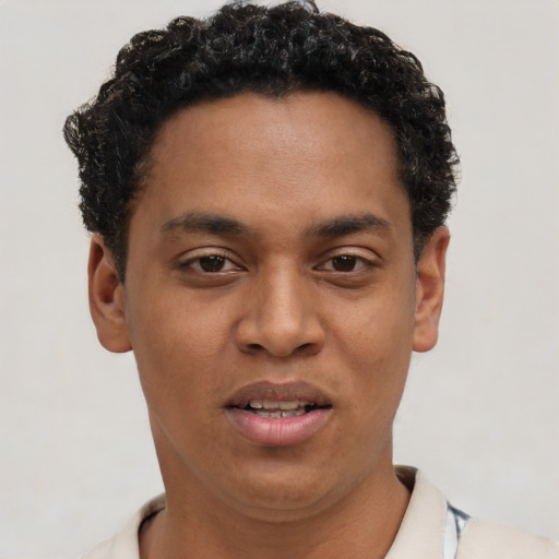 Joyful black young-adult male with short  black hair and brown eyes