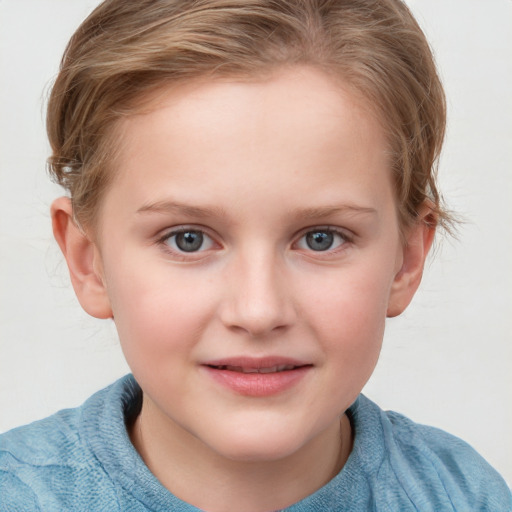 Joyful white child female with short  brown hair and blue eyes