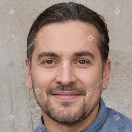 Joyful white adult male with short  brown hair and brown eyes