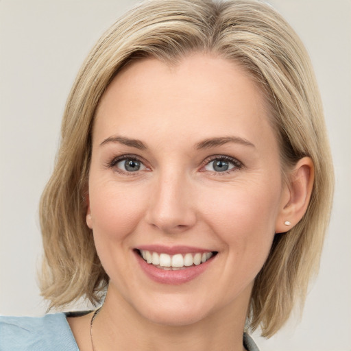 Joyful white young-adult female with medium  brown hair and blue eyes