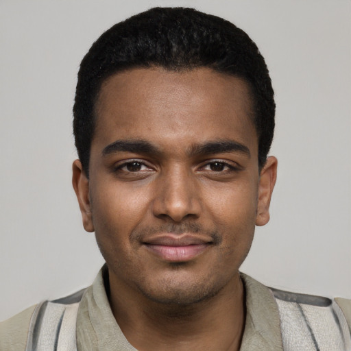 Joyful black young-adult male with short  black hair and brown eyes