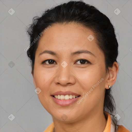 Joyful latino adult female with short  brown hair and brown eyes