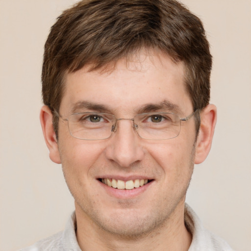 Joyful white adult male with short  brown hair and grey eyes