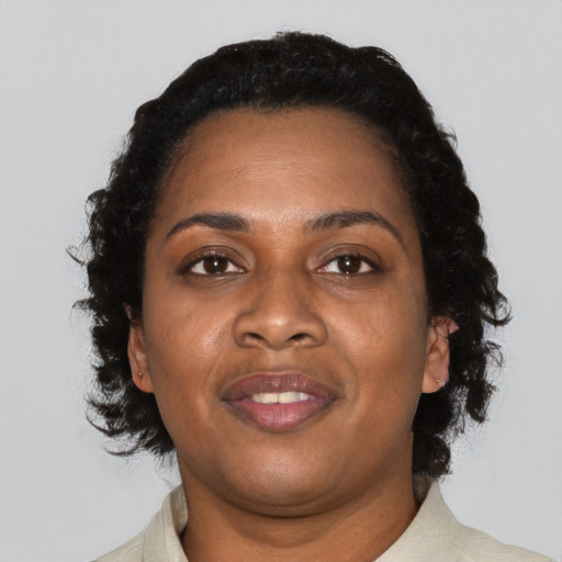 Joyful black adult female with medium  black hair and brown eyes