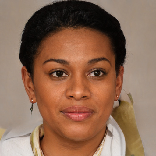 Joyful black young-adult female with short  brown hair and brown eyes
