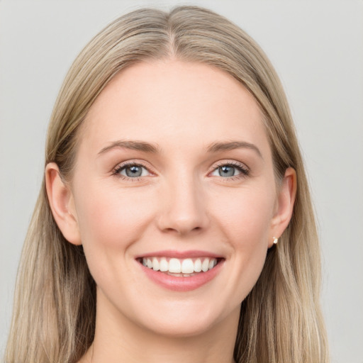 Joyful white young-adult female with long  brown hair and blue eyes