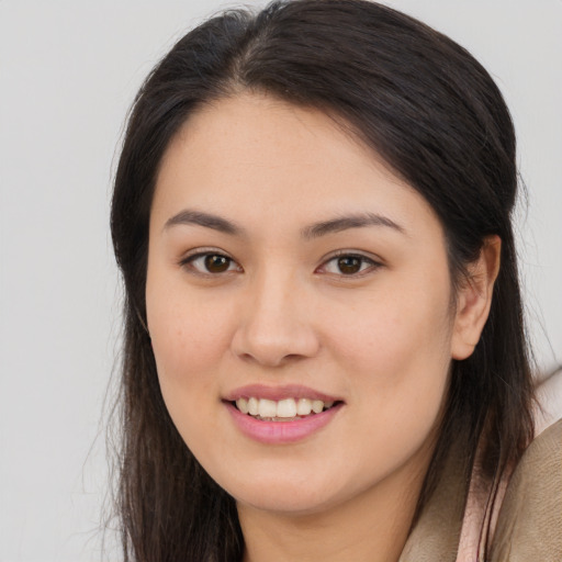 Joyful asian young-adult female with long  brown hair and brown eyes