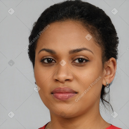 Joyful black young-adult female with long  brown hair and brown eyes