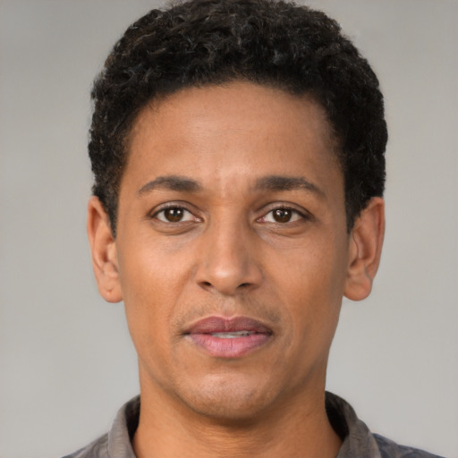 Neutral latino adult male with short  black hair and brown eyes