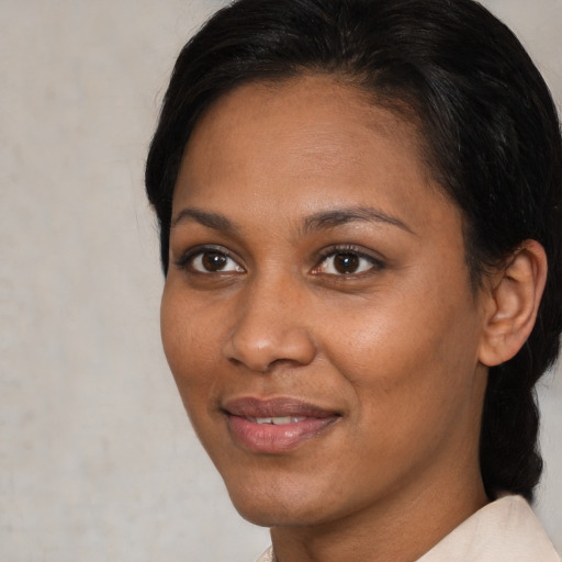 Joyful black young-adult female with medium  brown hair and brown eyes