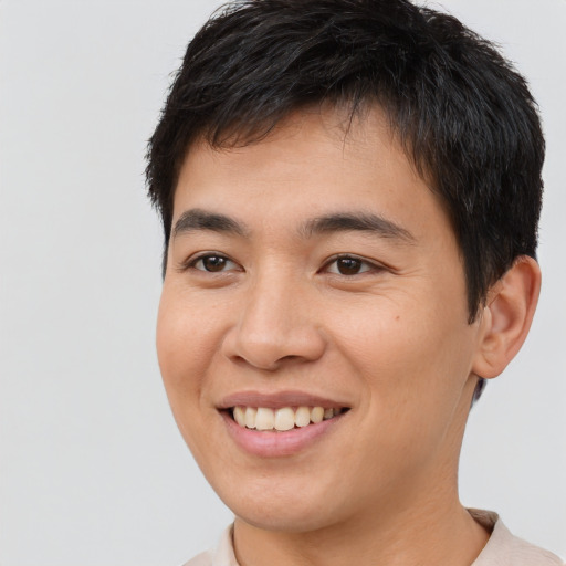 Joyful asian young-adult male with short  brown hair and brown eyes