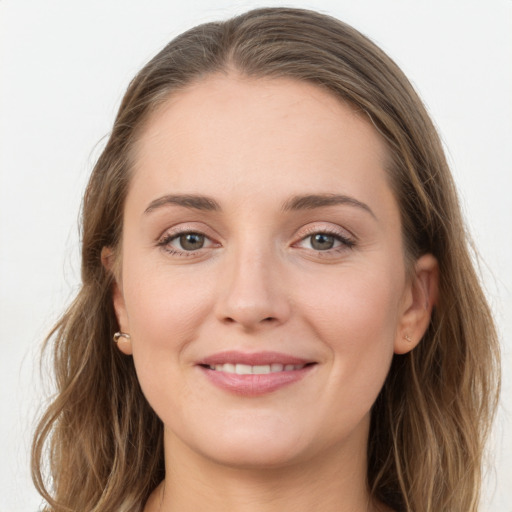 Joyful white young-adult female with long  brown hair and grey eyes