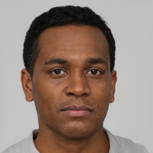 Neutral black young-adult male with short  black hair and brown eyes