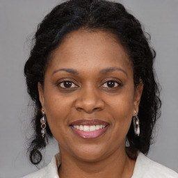 Joyful black adult female with medium  brown hair and brown eyes