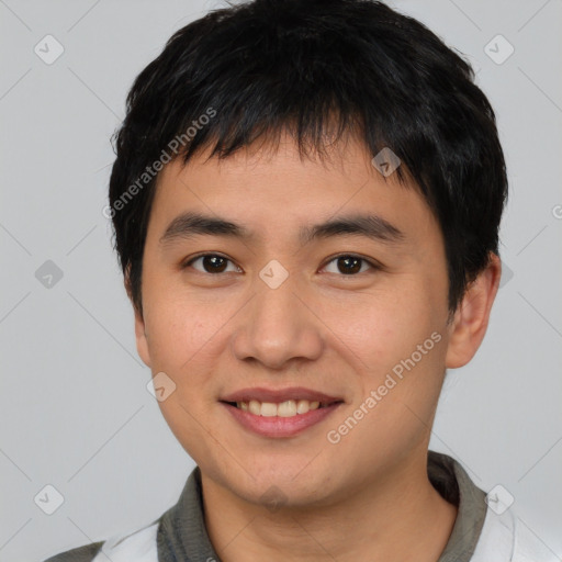 Joyful asian young-adult male with short  brown hair and brown eyes