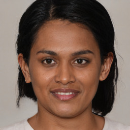 Joyful black young-adult female with medium  black hair and brown eyes