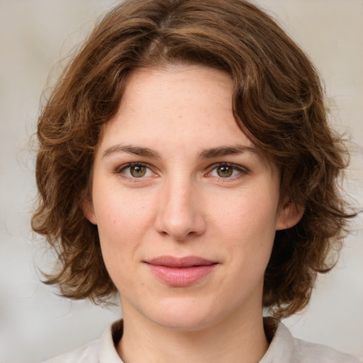 Joyful white young-adult female with medium  brown hair and green eyes