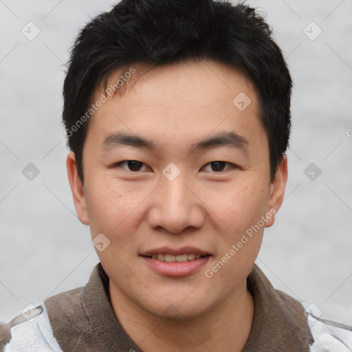 Joyful asian young-adult male with short  brown hair and brown eyes