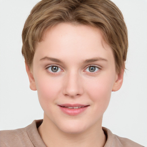 Joyful white young-adult female with short  brown hair and grey eyes