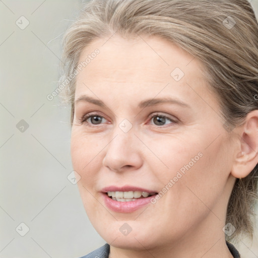 Joyful white young-adult female with medium  brown hair and blue eyes