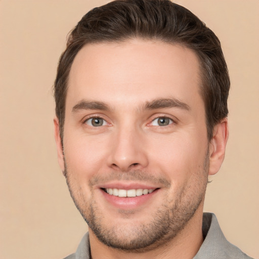 Joyful white young-adult male with short  brown hair and brown eyes