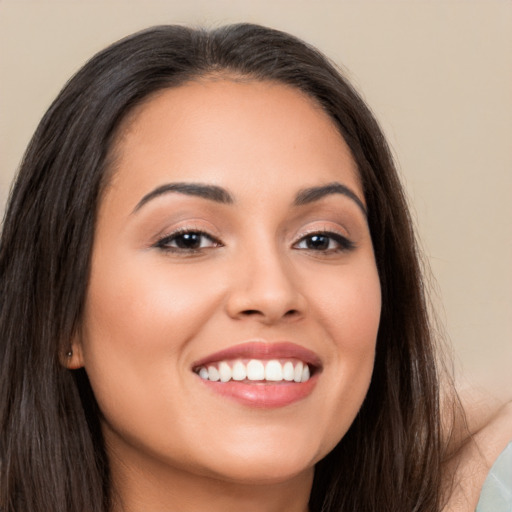 Joyful white young-adult female with long  brown hair and brown eyes