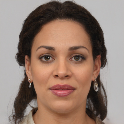 Joyful latino young-adult female with medium  brown hair and brown eyes