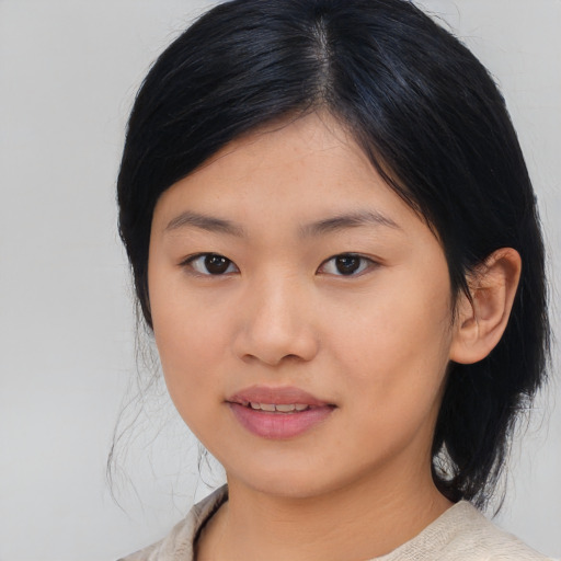 Joyful asian young-adult female with medium  black hair and brown eyes