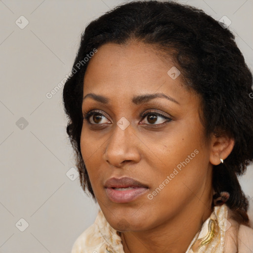 Joyful black adult female with medium  brown hair and brown eyes