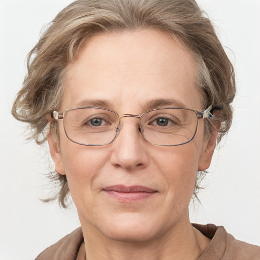 Joyful white middle-aged female with medium  brown hair and grey eyes