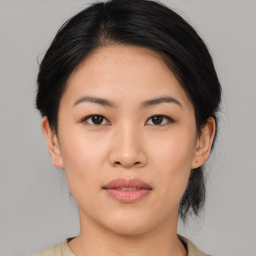 Joyful asian young-adult female with medium  black hair and brown eyes