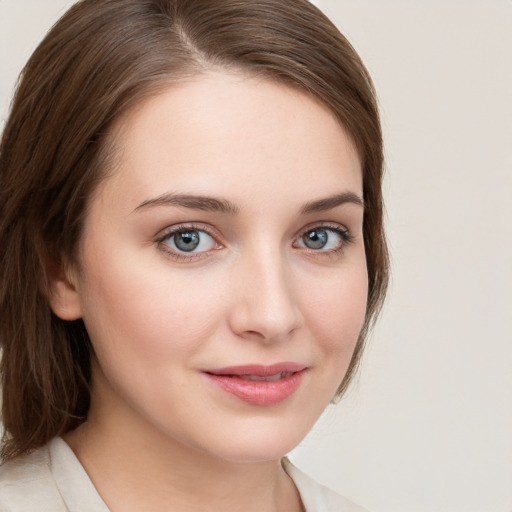 Joyful white young-adult female with long  brown hair and blue eyes