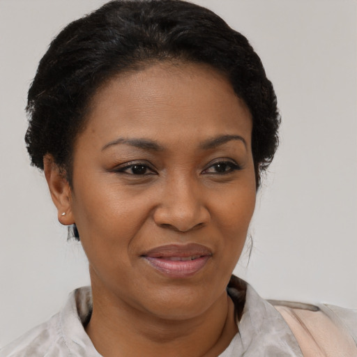 Joyful black adult female with short  brown hair and brown eyes