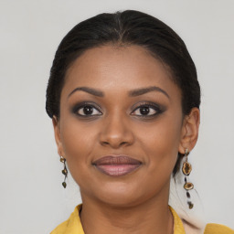 Joyful black young-adult female with medium  brown hair and brown eyes