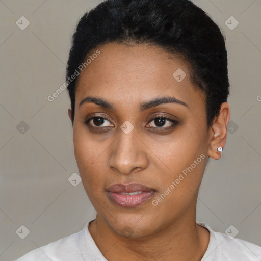 Joyful black young-adult female with short  black hair and brown eyes