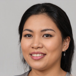 Joyful latino young-adult female with medium  brown hair and brown eyes