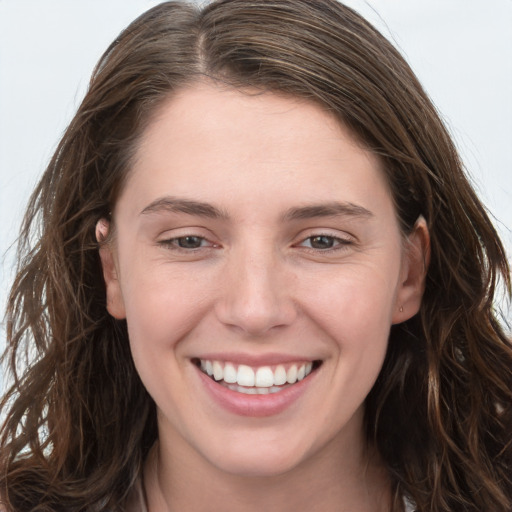 Joyful white young-adult female with long  brown hair and grey eyes