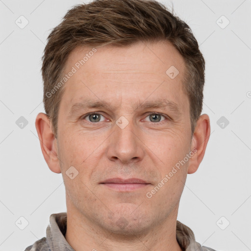 Joyful white adult male with short  brown hair and grey eyes