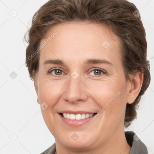 Joyful white adult female with short  brown hair and grey eyes