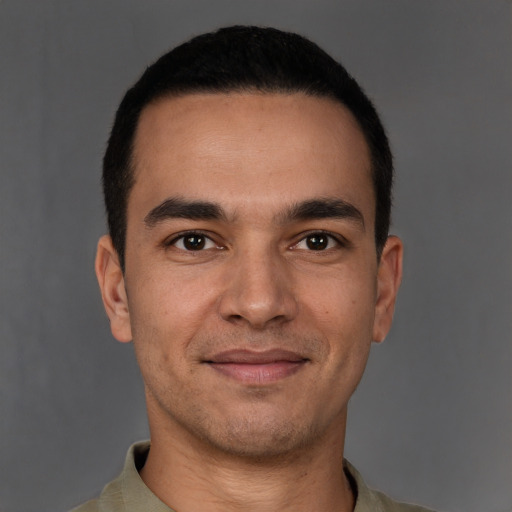 Joyful white young-adult male with short  black hair and brown eyes