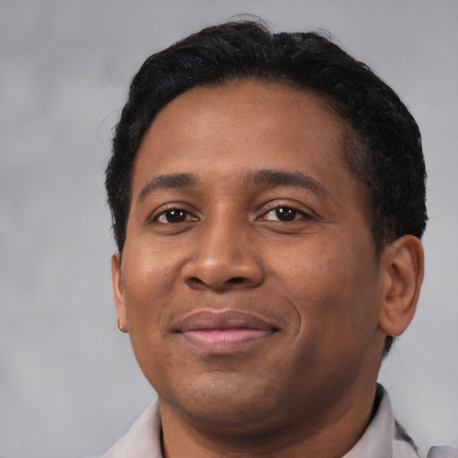 Joyful latino adult male with short  black hair and brown eyes