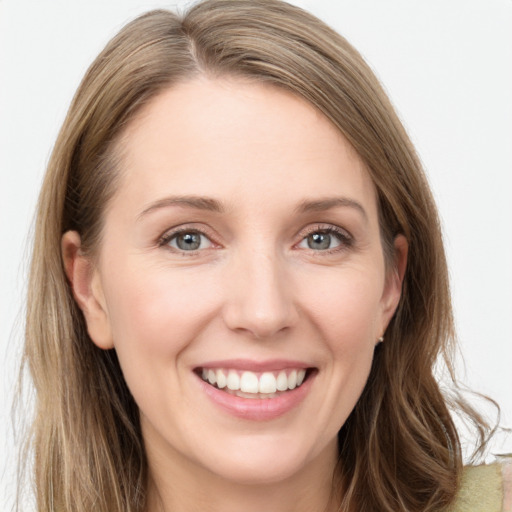 Joyful white young-adult female with long  brown hair and grey eyes