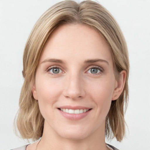 Joyful white young-adult female with medium  brown hair and blue eyes