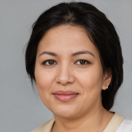 Joyful asian adult female with medium  brown hair and brown eyes
