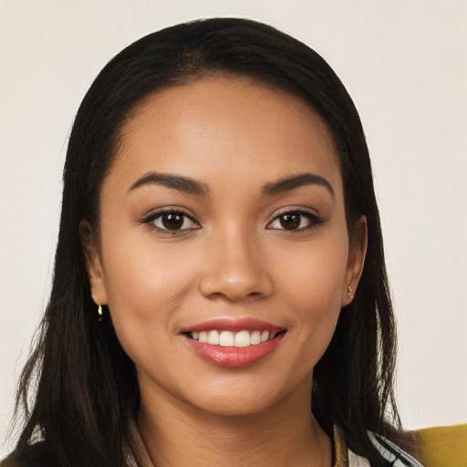 Joyful latino young-adult female with long  brown hair and brown eyes