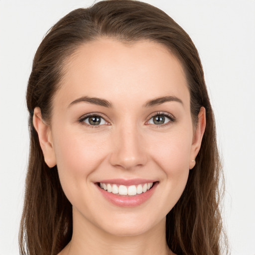 Joyful white young-adult female with long  brown hair and grey eyes