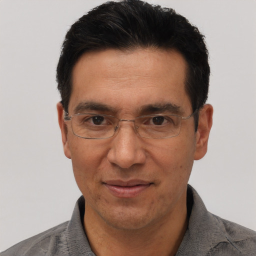 Joyful asian adult male with short  black hair and brown eyes