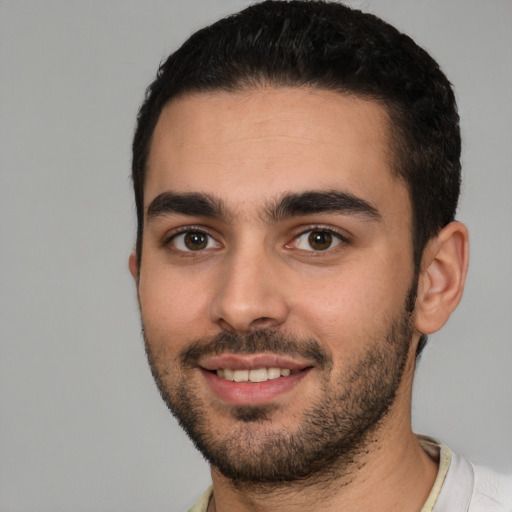 Joyful white young-adult male with short  black hair and brown eyes